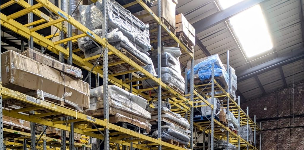 Warehouse racking full of customer returns pallets